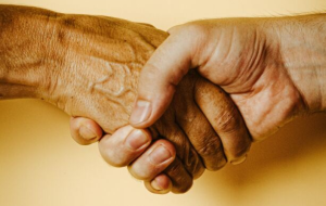 a handshake in front of a yellow background